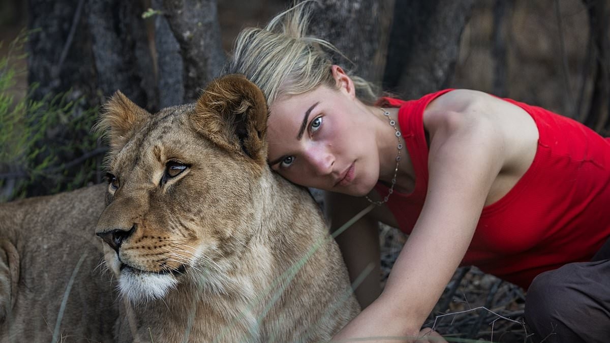 Nepo baby, 21, is spitting image of '90s TV star mother as she cuddles lion in Africa - but can you guess who her famous parent is?