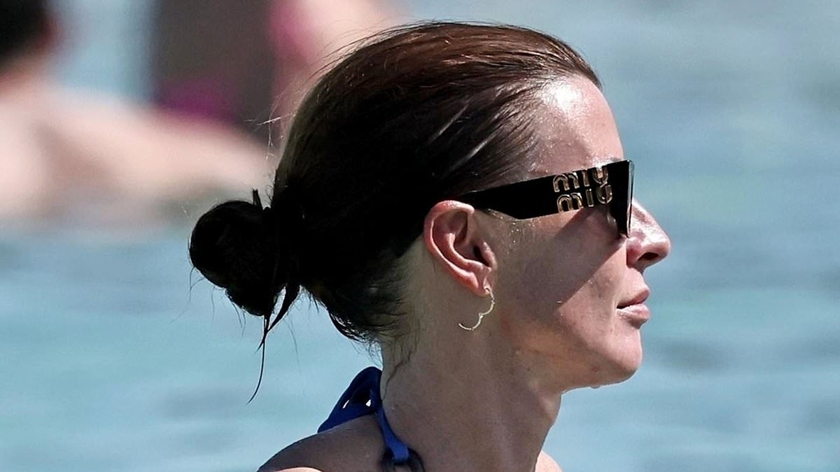 Coleen Rooney shows off her toned figure in a blue bikini as she soaks up the sun at beach club in Ibiza with husband Wayne - after winning Wagatha Christie battle