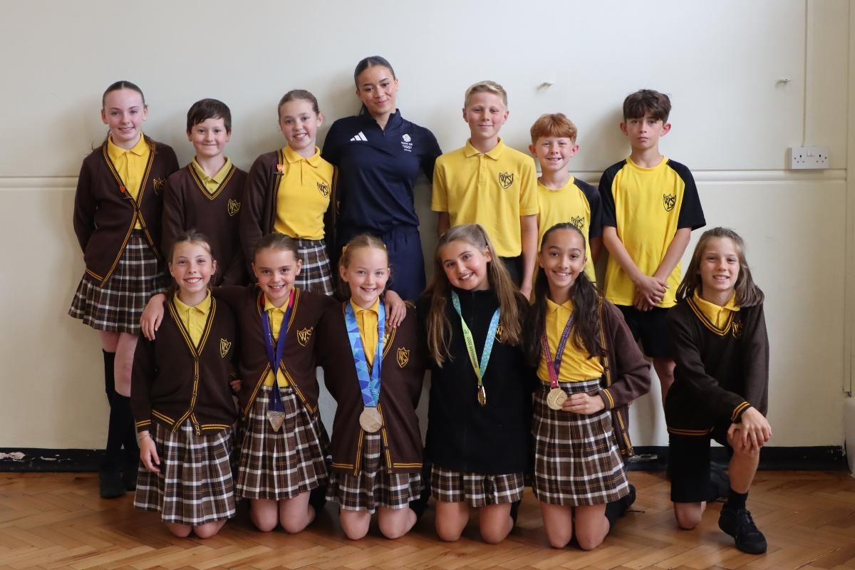 Children get to hold Olympic medals as part of Careers Day at school in Leigh