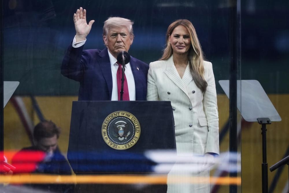 Gathering stormclouds can't wipe smile from Trump's face as long-held dream of military parade is realised