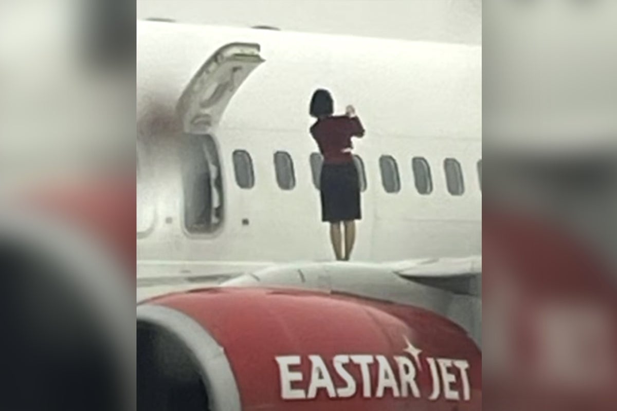 South Korean flight attendants caught taking photos while standing on plane wing