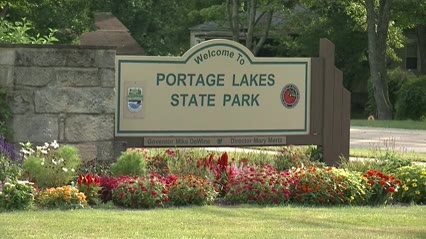 Driver dies after car plunges into Portage Lakes