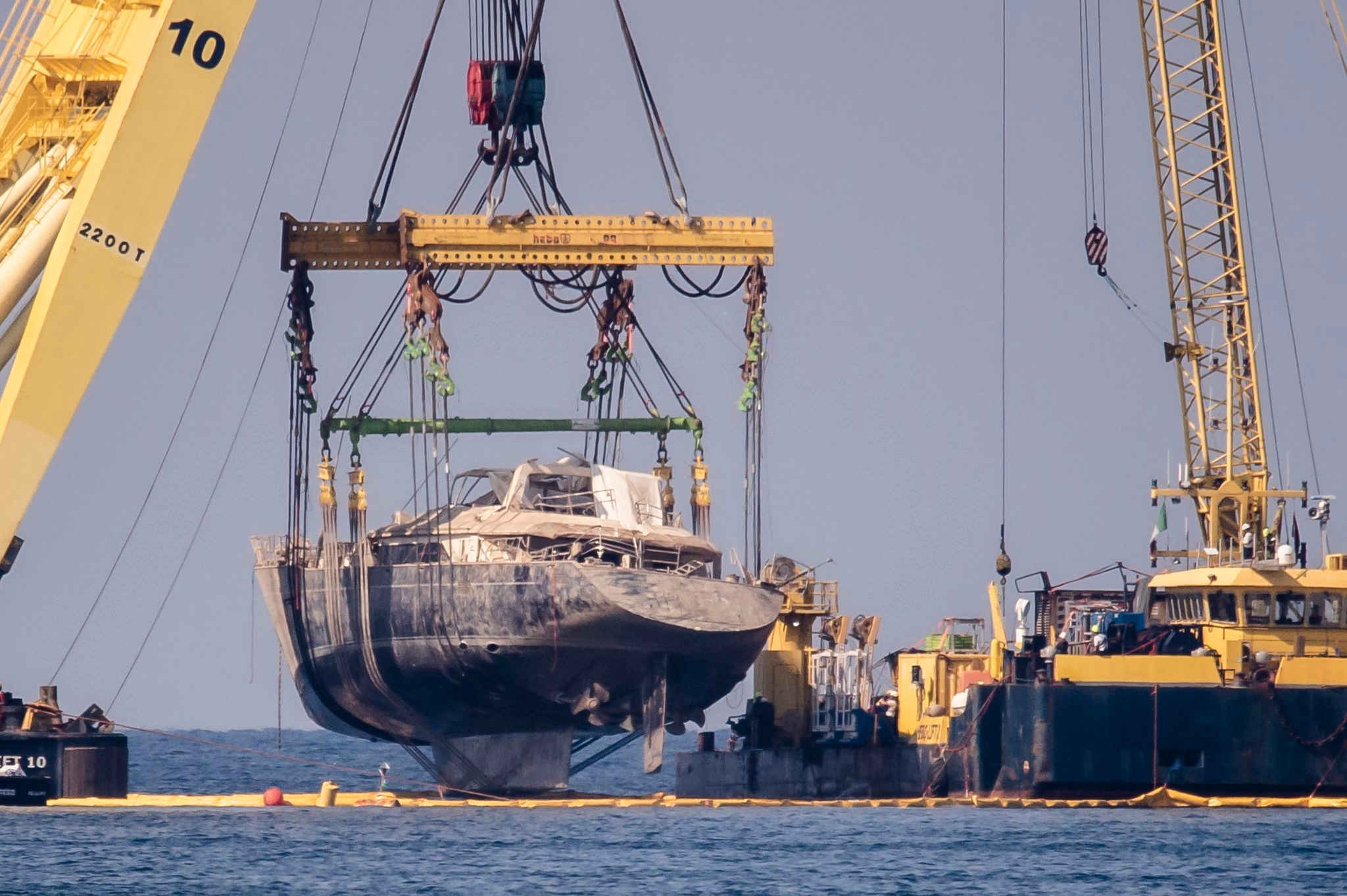 Photos of luxury superyacht that sank off Sicily, killing 7, being lifted from the ocean