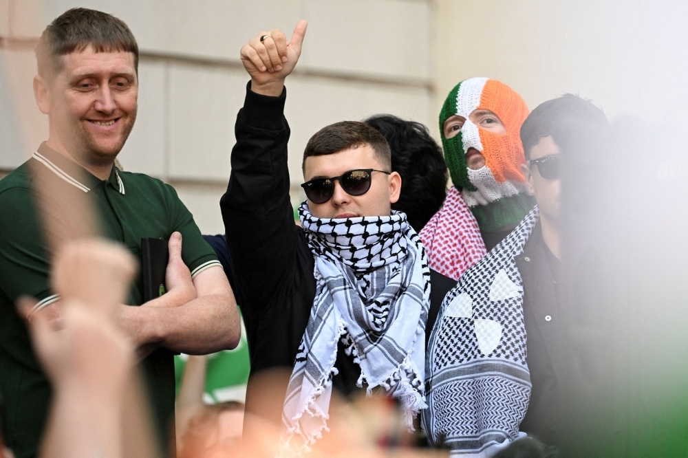 Hundreds rally behind Kneecap's Mo Chara as he faces UK terrorism charge for Hezbollah flag display