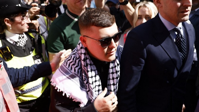 Kneecap rapper granted bail on terror charge over Hezbollah flag at London gig