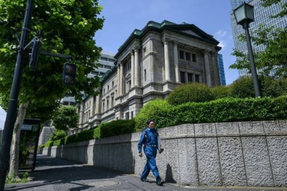 BOJ holds rates, says it will slow bond purchase taper