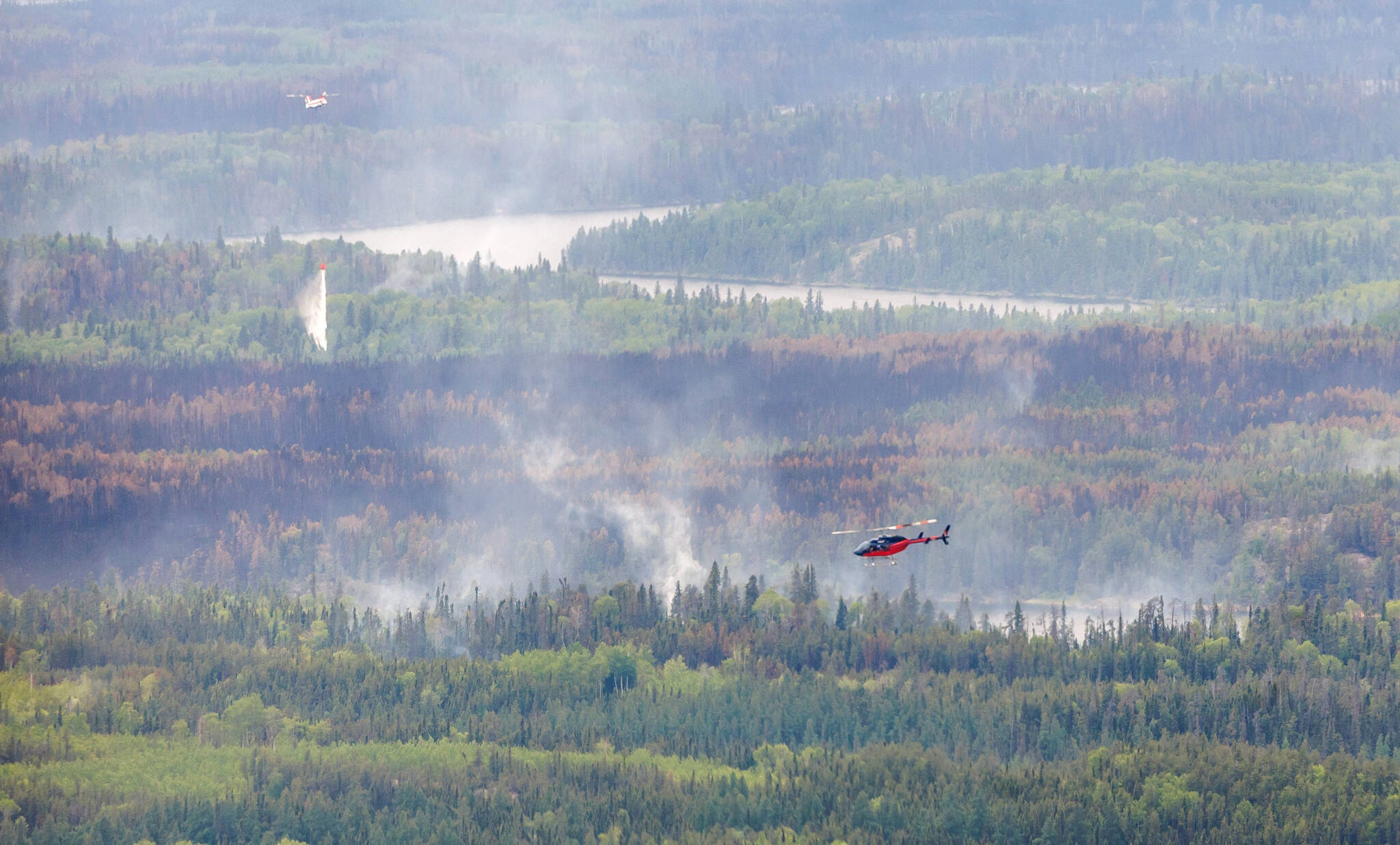 Extinguishing massive out-of-control wildfires in Manitoba is unrealistic; priority is to slow the destruction, wait for rain